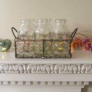 vintage style mini bottles in a wire basket by the flower studio