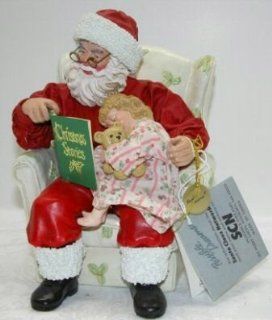 Possible Dreams ClothtiqueTM American Artist Tom Browning Christmas Stories #15054 RETIRED Featuring Santa Sitting in a Chair reading a book title Christmas Stories to a Little Girl Who Has Fallen Asleep with a Teddy Bear In Her Arms   Holiday Figurines